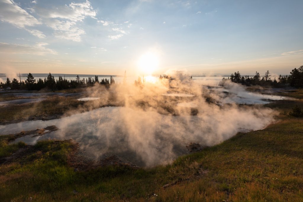 West Thumb geyser basin at sunrise, a great place to see Yellowstone mudpots