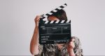 Woman with film clapboard