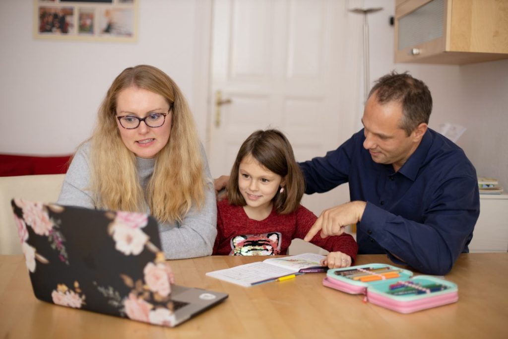Child and parents at home school