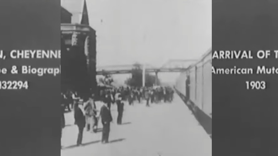 A still from 1903 footage showing a steam engine arriving at a train platform in Cheyenne, Wyoming