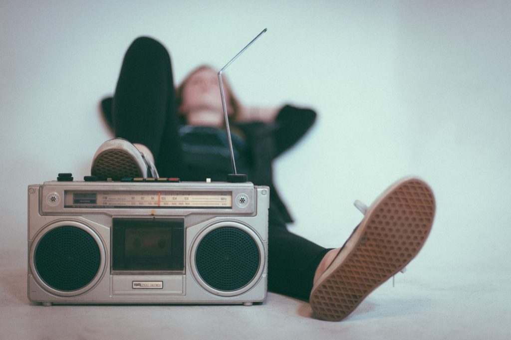 Young lad reclining while listening to radio
