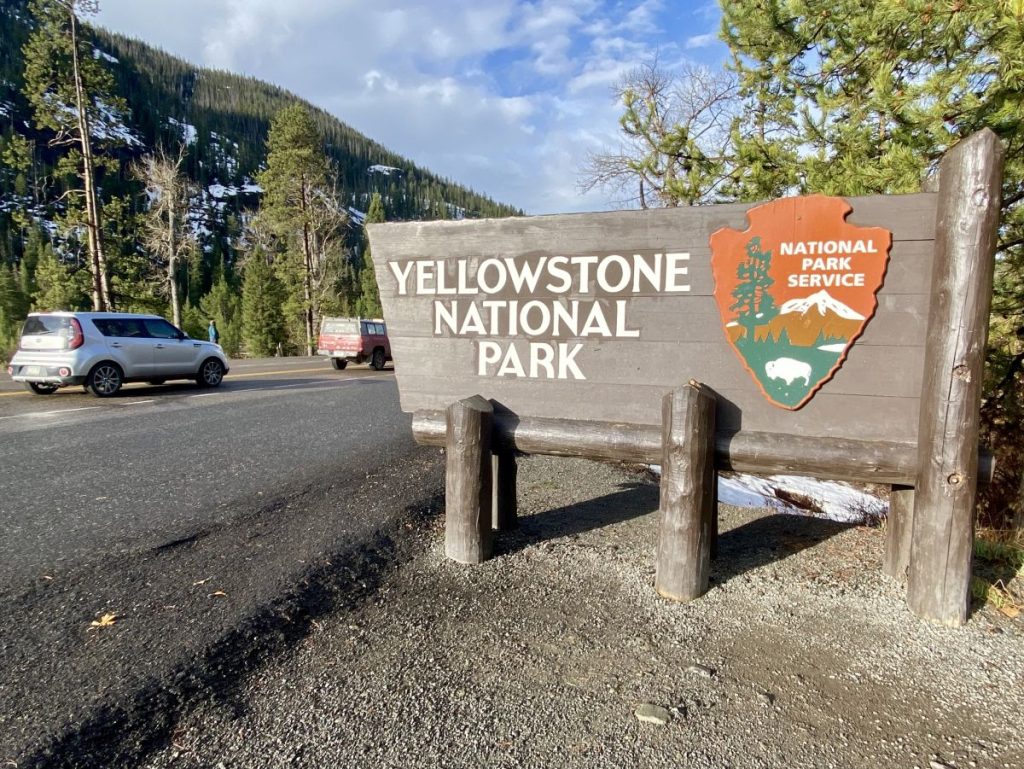 Yellowstone's East Entrance sign on Opening Day (May 5, 2023), a gateway to Wyoming destinations beyond Yellowstone.
