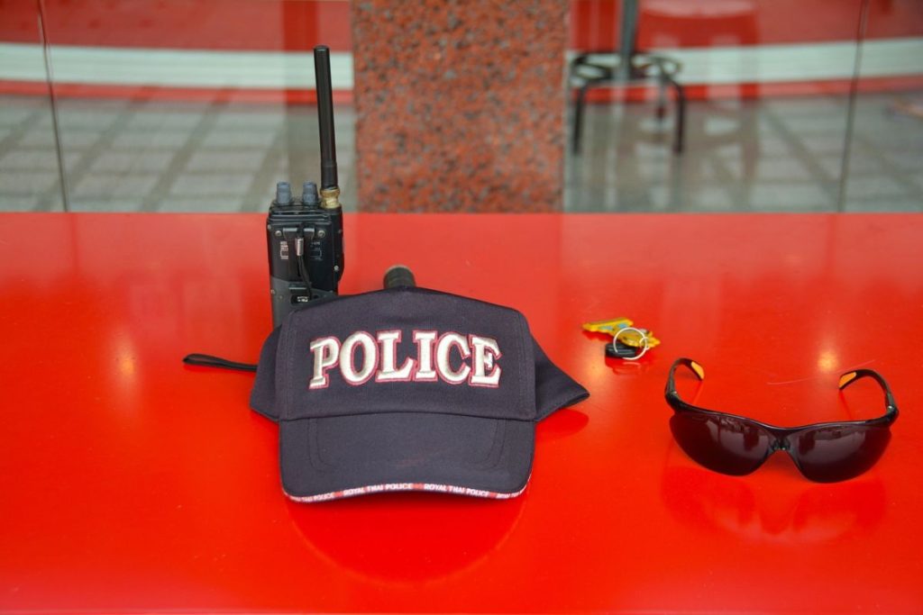 Police hat with sunglasses and portable radio