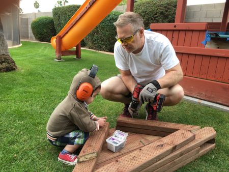 Mac and his son building a playset