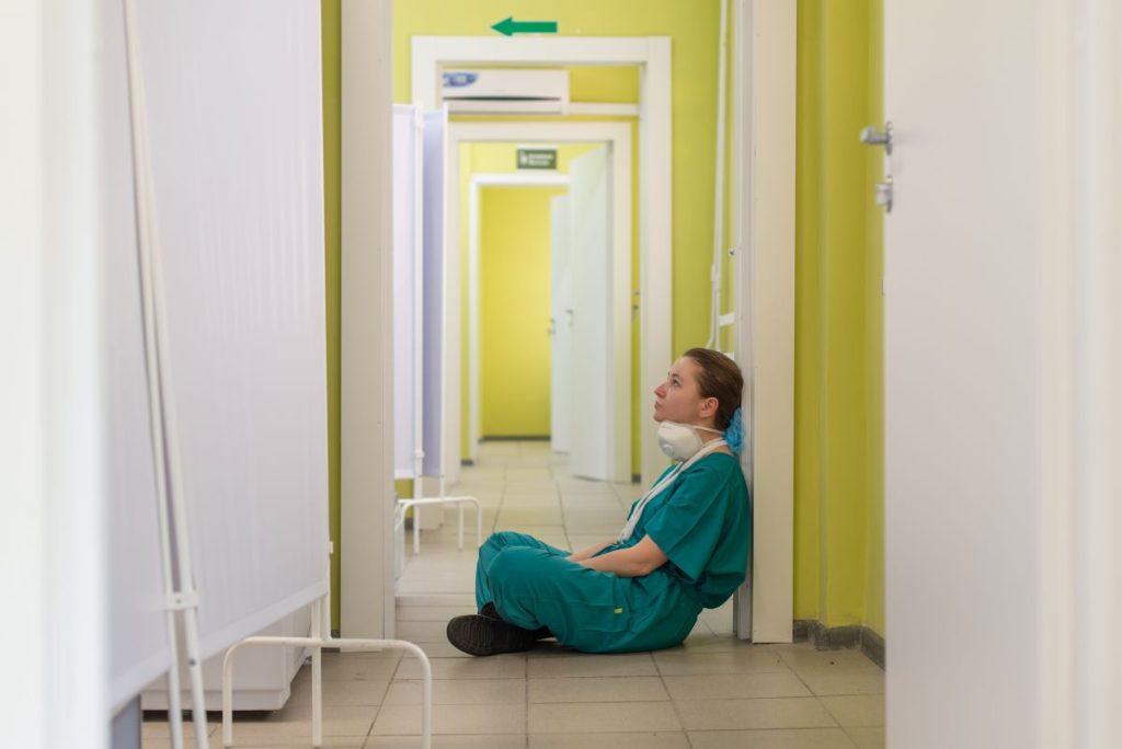 nurse sitting in hospital hallway